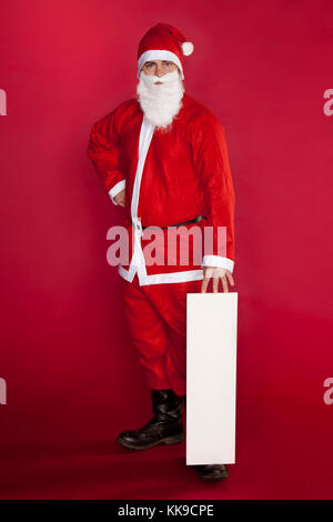 Disappointed Santa Claus is backed by advertising Stock Photo