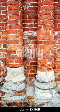 Brick columns of red brick, round in the city, abandoned building in the summer. Stock Photo