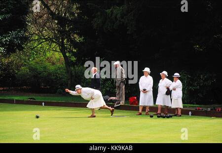English ladies and gentlemen playing crown green bowling in the town of Barnard Castle, County Durham, England, UK. Summer. Stock Photo