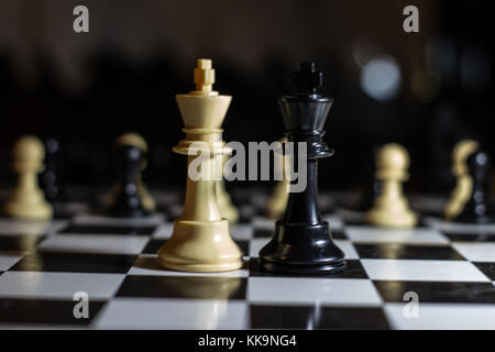 two kings chess board facing each other against a revolution from the pawns alliance Stock Photo