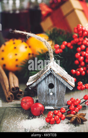 Bright christmas composition with small bird house and mulled wine Stock Photo