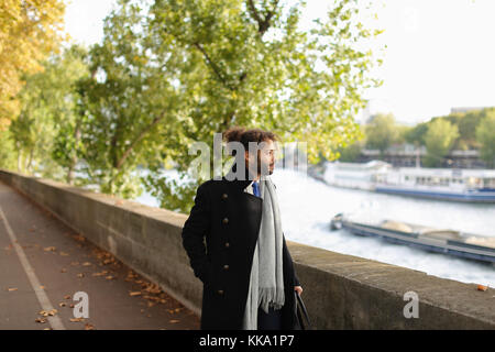 Half Nigerian man strolling near river. Stock Photo