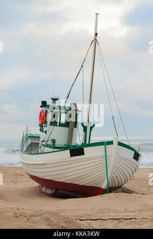 Fishing boat on the beach in the costline Stock Photo