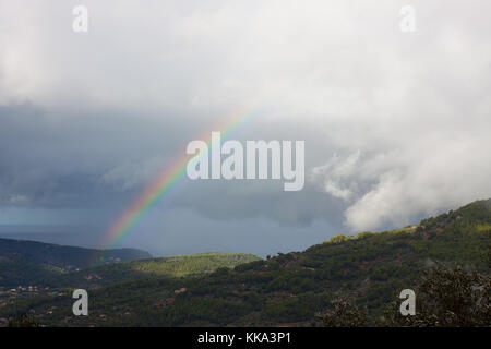 Rainbow over Soller Valley surrounded by the Serra de Tramuntana mountains. Majorca, Spain Stock Photo