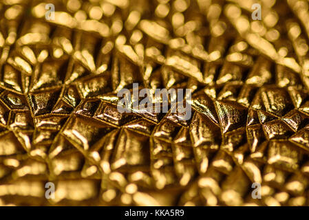 Abstract embossed gold surface background. Stock Photo