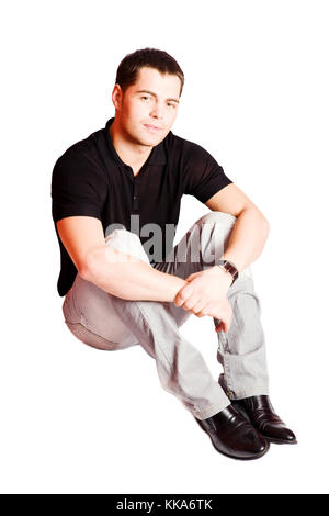 Young man wearing casual closes sitting isolated on white Stock Photo