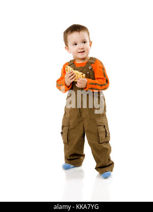 two years boy eating and walking isolated on white