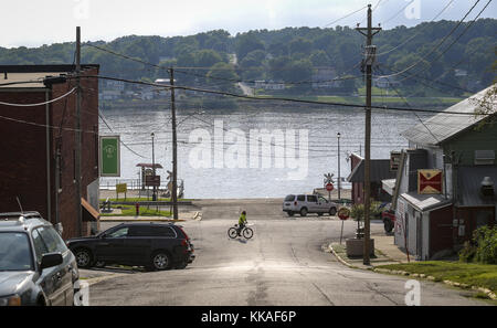 Port Byron, Iowa, USA. 2nd Aug, 2017. A cyclist rides South Main Street in Port Byron, Illinois, with the Mississippi River in the background on Wednesday, August 2, 2017. Credit: Andy Abeyta, Quad-City Times/Quad-City Times/ZUMA Wire/Alamy Live News Stock Photo