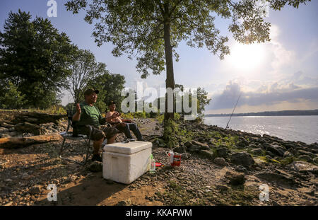 Hampton, Iowa, USA. 2nd Aug, 2017. Pino De La Cruz of Chicago, left, tells his son, Joseph, fish stories as the two watch their lines at Illiniwek Campground in Hampton, Illinois, on Wednesday, August 2, 2017. The father and son duo had been fishing for about three hours after driving from Chicago to come to this spot. They were catching white bass and catfish. Credit: Andy Abeyta, Quad-City Times/Quad-City Times/ZUMA Wire/Alamy Live News Stock Photo