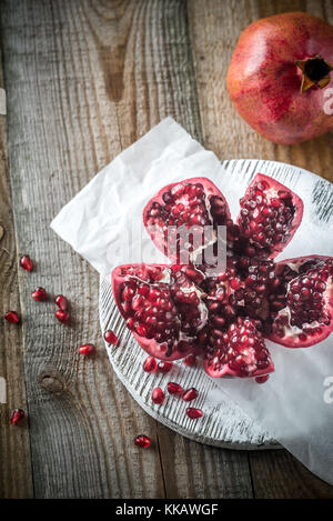 Pomegranate on the wooden board Stock Photo