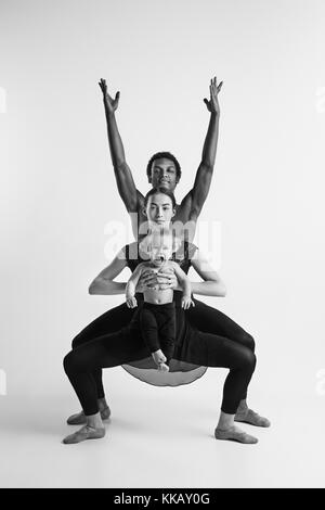 A happy family of ballet dancers on white studio background Stock Photo