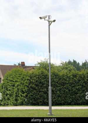 Two security monitoring, video cameras on high metal pole outdoor Stock Photo
