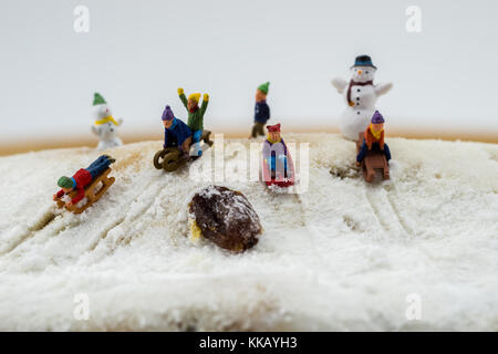 winter concept children sliding down snowy mountain cake Stock Photo