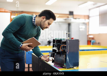 Young student of mechatronics working on project Stock Photo