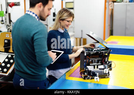 Young attractive students of mechatronics working on project Stock Photo