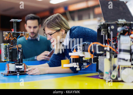 Young attractive students of mechatronics working on project Stock Photo