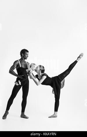 A happy family of ballet dancers on white studio background Stock Photo