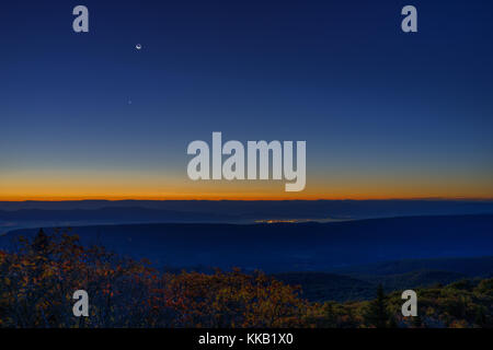 Morning dark sunrise with blue sky and golden yellow orange autumn foliage in Dolly Sods, Bear Rocks, West Virginia with overlook of mountain valley,  Stock Photo