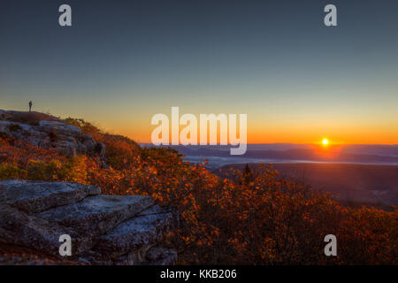 Standing man in distance silhouette far away on autumn morning in Bear Rocks, West Virginia looking at sunrise Stock Photo