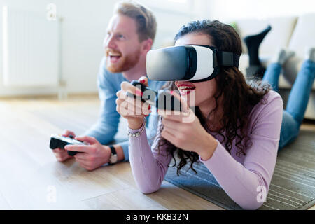 Young couple playing games with virtual reality headset Stock Photo