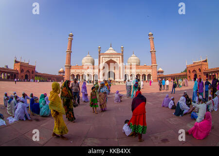 DELHI, INDIA - SEPTEMBER 27, 2017: Crowd of people walking in front of a beautiful Jama Masjid temple, this is the largest muslim mosque in India. Delhi, India, fish eye effect Stock Photo