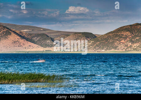 Boat, reed at Bear Lake, Black Mountain in distance, Bear Lake Valley near Garden City, Utah, USA Stock Photo