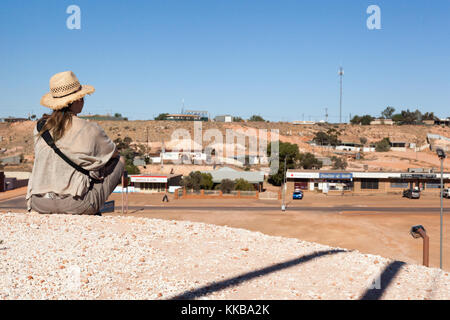 A lone female traveller looking over Coober Pedy from a hill Stock Photo