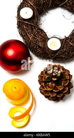 Top view of an advent wreath Happy X-Mas Time. Christmas composition. Christmas decoration, pine cone, branches, a peeled orange. White background. Fl Stock Photo