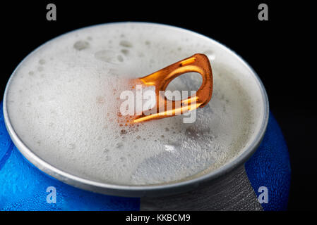Beer foam in open metal can isolated on black background Stock Photo