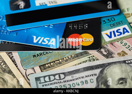 New york, USA - August 24, 2017: Close-up of visa and master card lay on dollar money background Stock Photo
