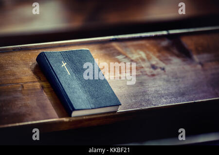 Book holy bible. Holy Bible on old wooden church table. Stock Photo