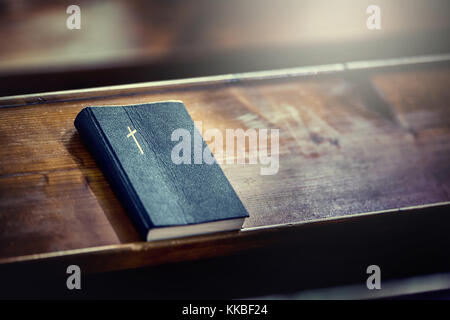Book holy bible. Holy Bible on old wooden church table. Stock Photo