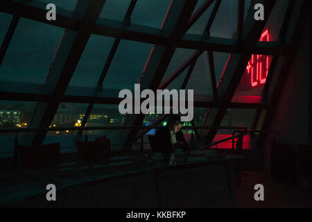 Businessman siting and using smartphone in night office. Stock Photo