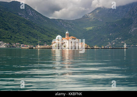 Our Lady of the Rocks church taken from a boat sailing in the Bay of Kotor, Montenegro. Stock Photo