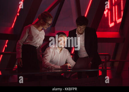 Group of business people working in a night office. Stock Photo