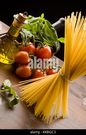 photo of different ingredients for italian pasta with tomatoes and basil Stock Photo
