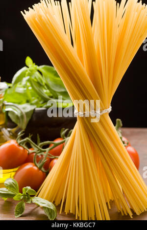 photo of different ingredients for italian pasta with tomatoes and basil Stock Photo