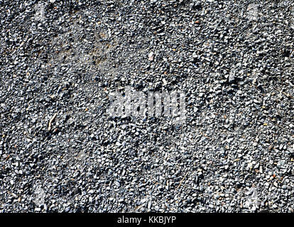 Granite gravel of macadam, rock gray crushed for construction on the ground, scree texture background. Stock Photo