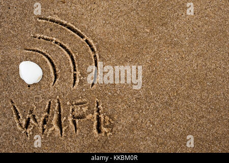 Wi fi sign drawn in the sand. Text wifi on sand. Stock Photo