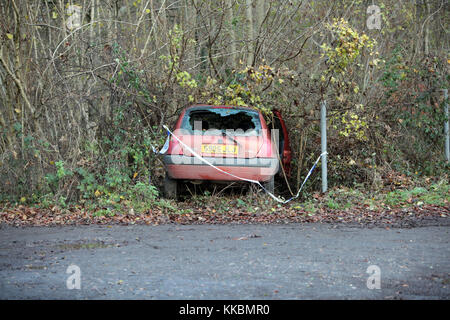 An abandoned car that crashed into a hedge on a rural road in Wiltshire England. Stock Photo