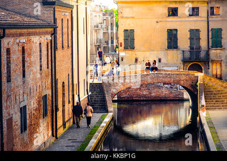 romantic getaways in italy,  warm tone lights at sunset over red bricks old buildings and bridge on the canal of Comacchio, Ferrara province Emilia Stock Photo