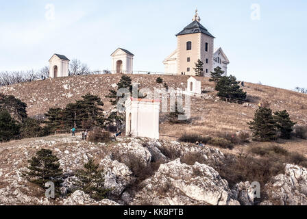 Svaty kopecek hill above Mikulov city in Czech republic with church, chapel, limestone rocks, grass and clear sky during springtime