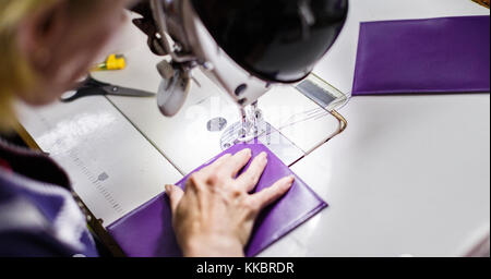 woman stitching a purse Stock Photo