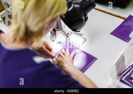 woman stitching a purse Stock Photo