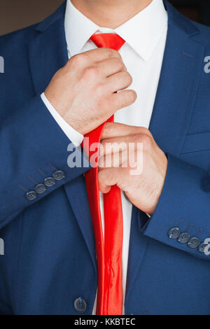 The man straightens his tie Stock Photo