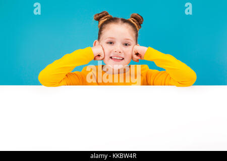 cute little red-haired girl in yellow pullover Stock Photo