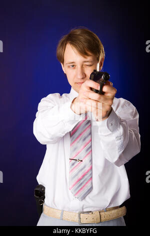 Portrait of handsome Young man holding gun isolated Stock Photo