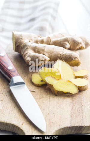 Sliced ginger root on cutting board. Stock Photo