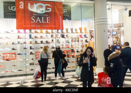 Shoppers in the Manhattan Mall in Herald Square in New York pass an UGG shoe display on Thanksgiving Day, Thursday, November 23, 2017. Many stores opened on Thanksgiving Day early to catch shoppers in a shopping mood. (© Richard B. Levine) Stock Photo