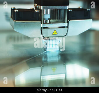 Head of industrial 3d printer in action. Stock Photo